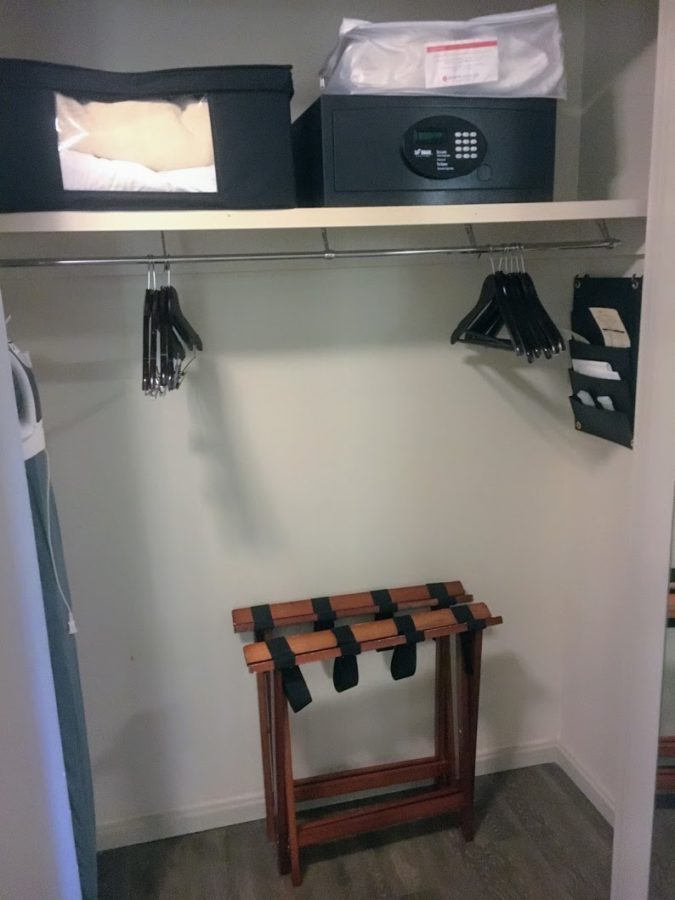 a closet with a small black box and swingers