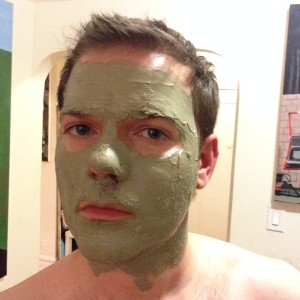 a man with green facial mask