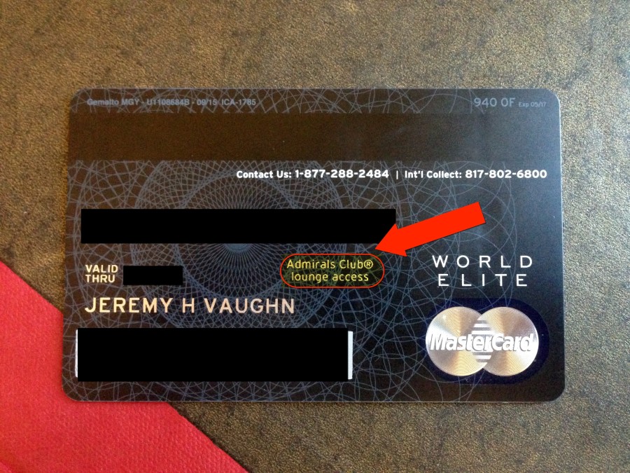 a credit card with a red arrow pointing to the side