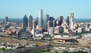 a city skyline with a highway and a large building