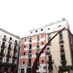 a tall metal object in front of a building