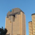 a tall building with a logo on top