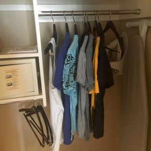 a closet with clothes on a rail