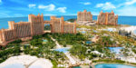 a large group of buildings with trees and water with Atlantis Paradise Island in the background