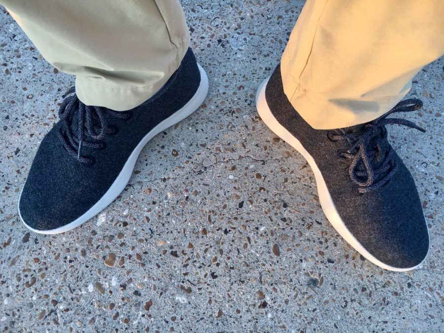 a pair of feet wearing blue shoes