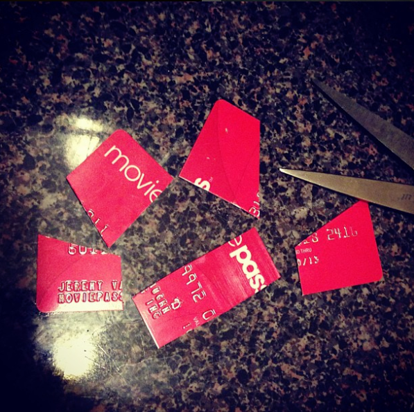 a pair of scissors next to a broken credit card