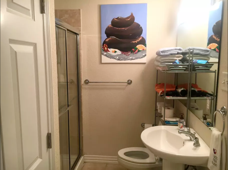 a bathroom with a painting of food