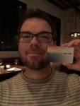 a man holding up a credit card
