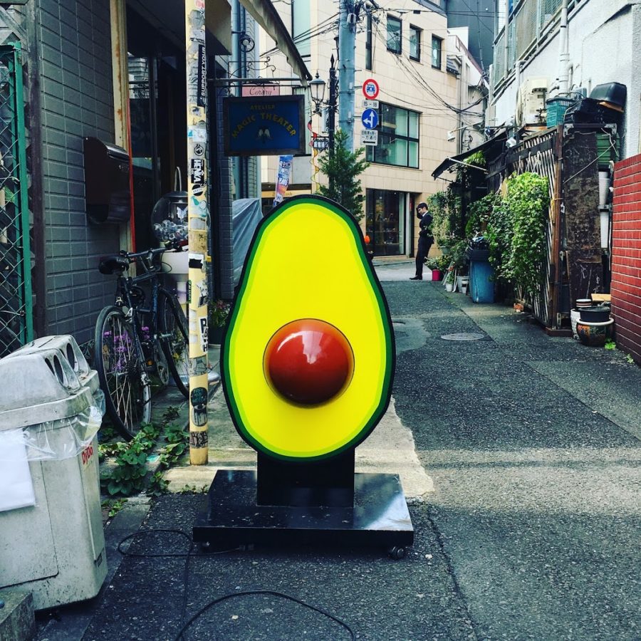 a large avocado statue on a street