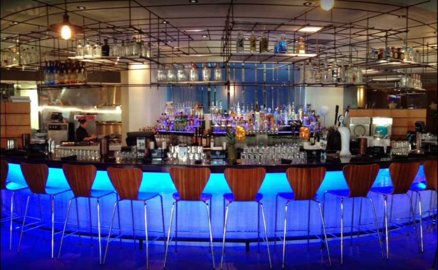 a bar with blue lights and chairs