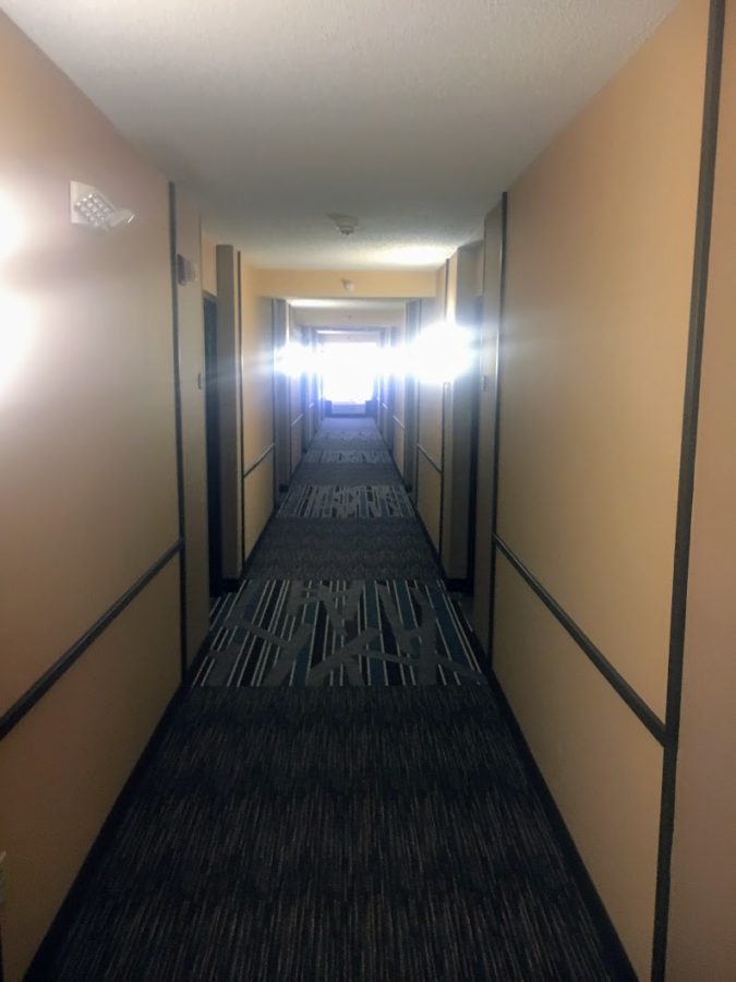 a hallway with light shining through the walls
