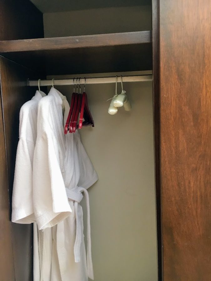 a closet with white robes and swingers