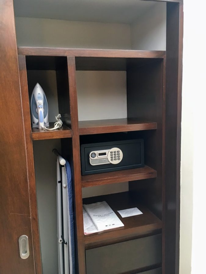 a wooden shelf with a safe and iron