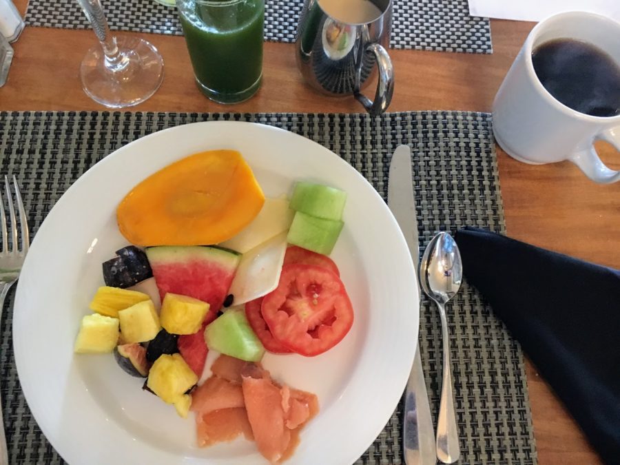 a plate of fruit and vegetables on a place mat