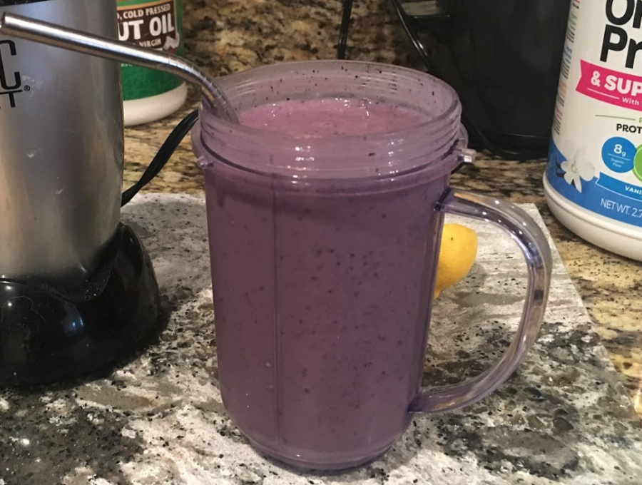a purple smoothie in a glass mug with a straw