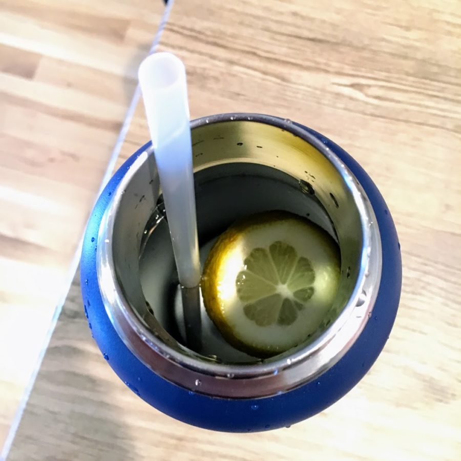 a blue cup with a lemon slice in it