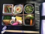 a tray of food with chopsticks