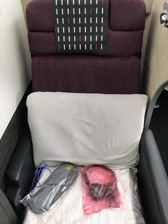 a chair with a pillow and a pillow and a mask