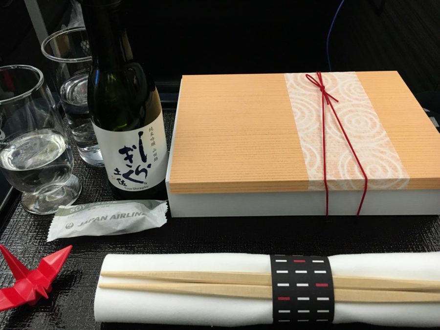 a table with a bottle and chopsticks