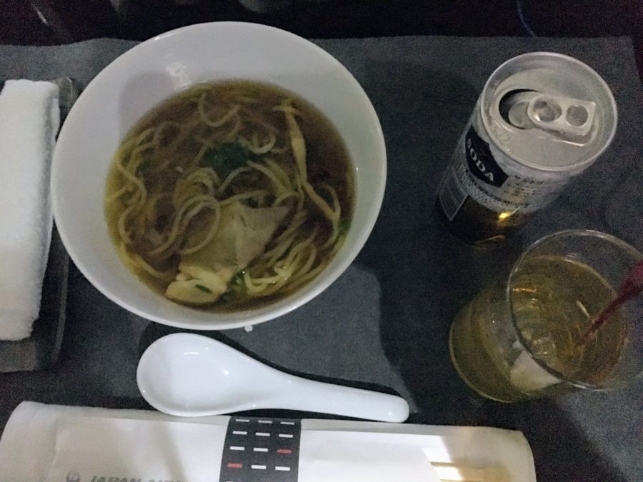 a bowl of soup and a can of soda