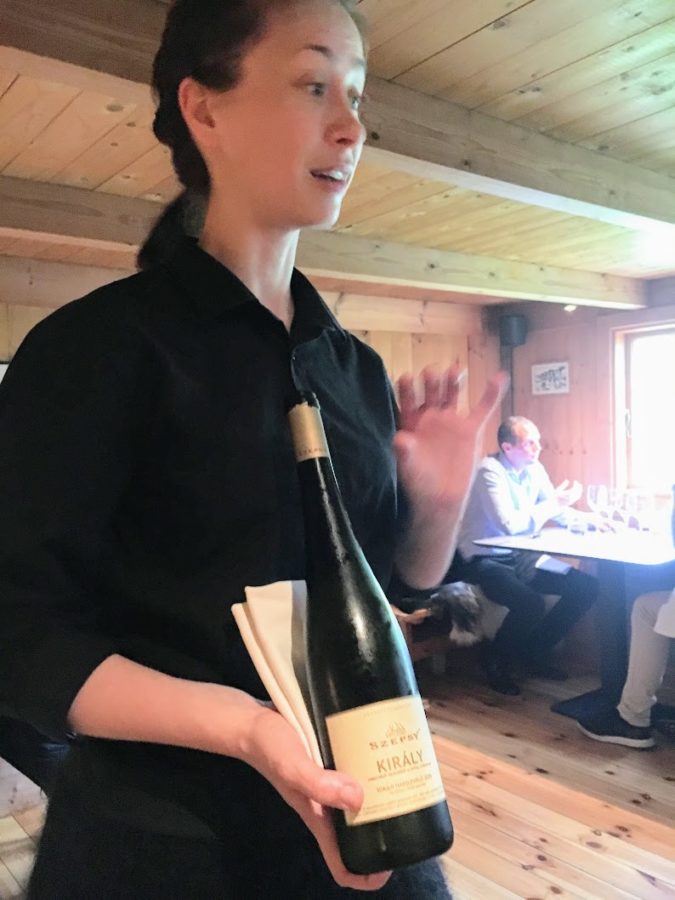 a woman holding a bottle of wine
