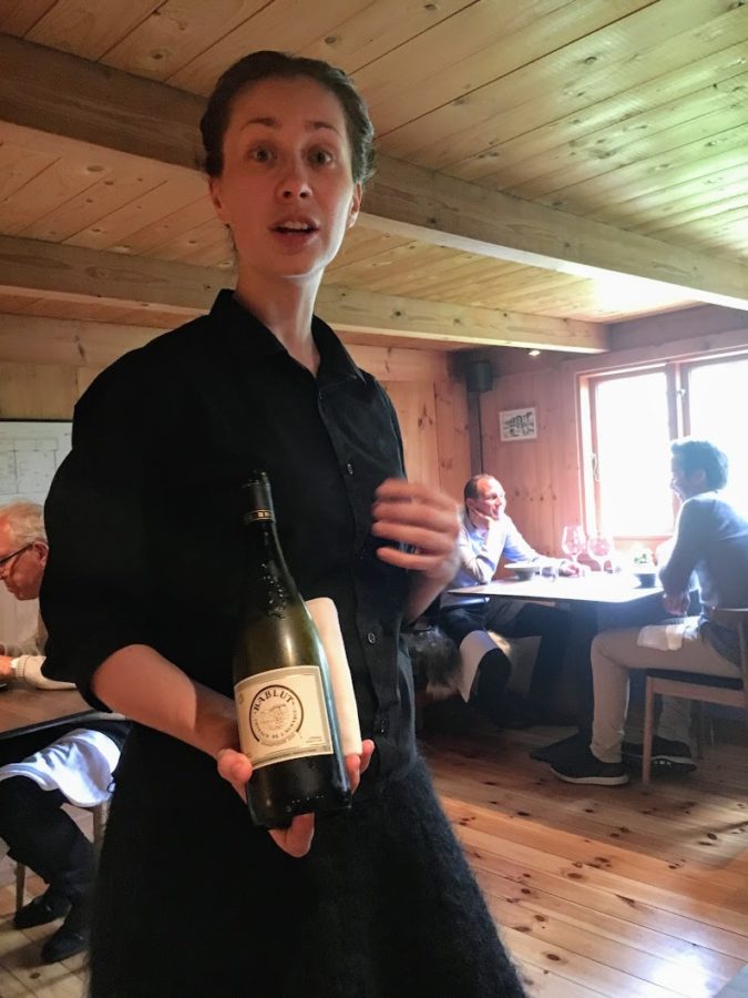a person holding a bottle of wine
