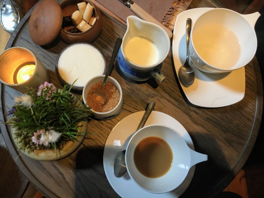 a table with a variety of dishes and cups