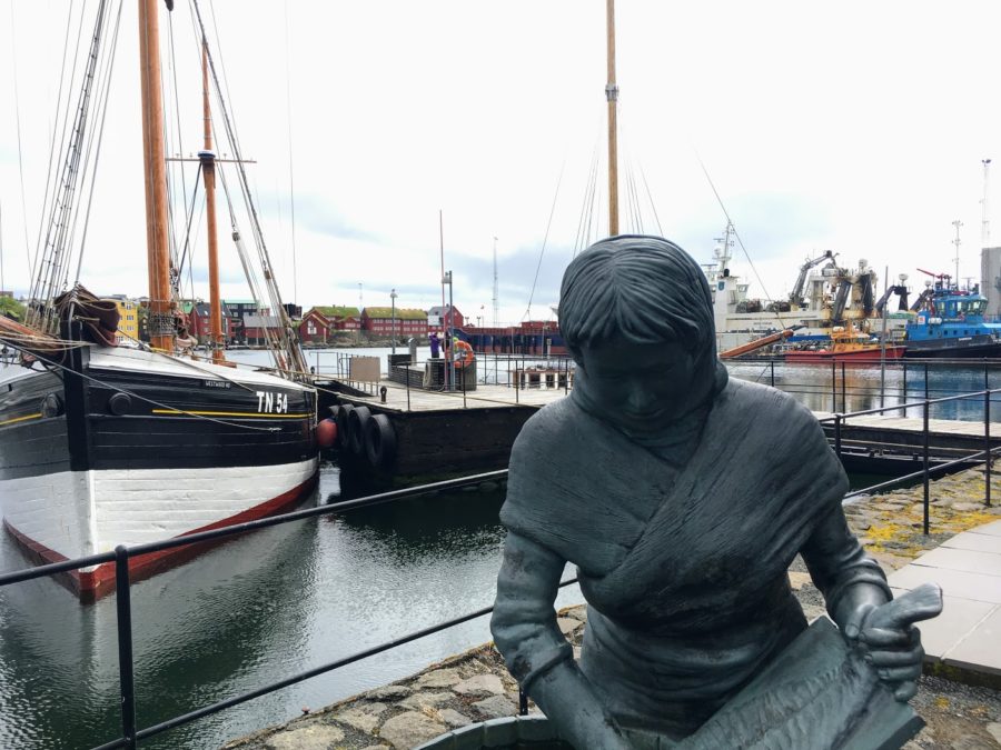 a statue of a woman in a harbor