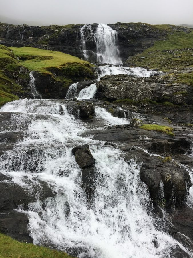 a waterfall on a rocky hillside