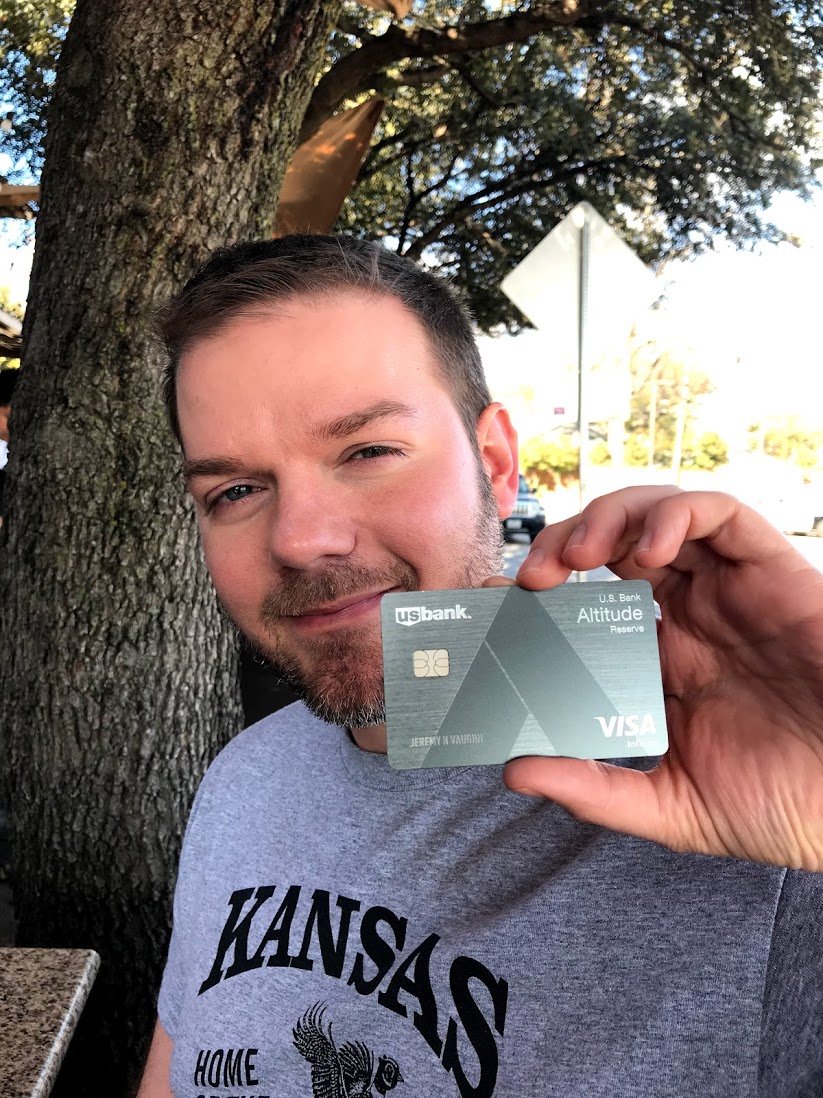 a man holding up a credit card