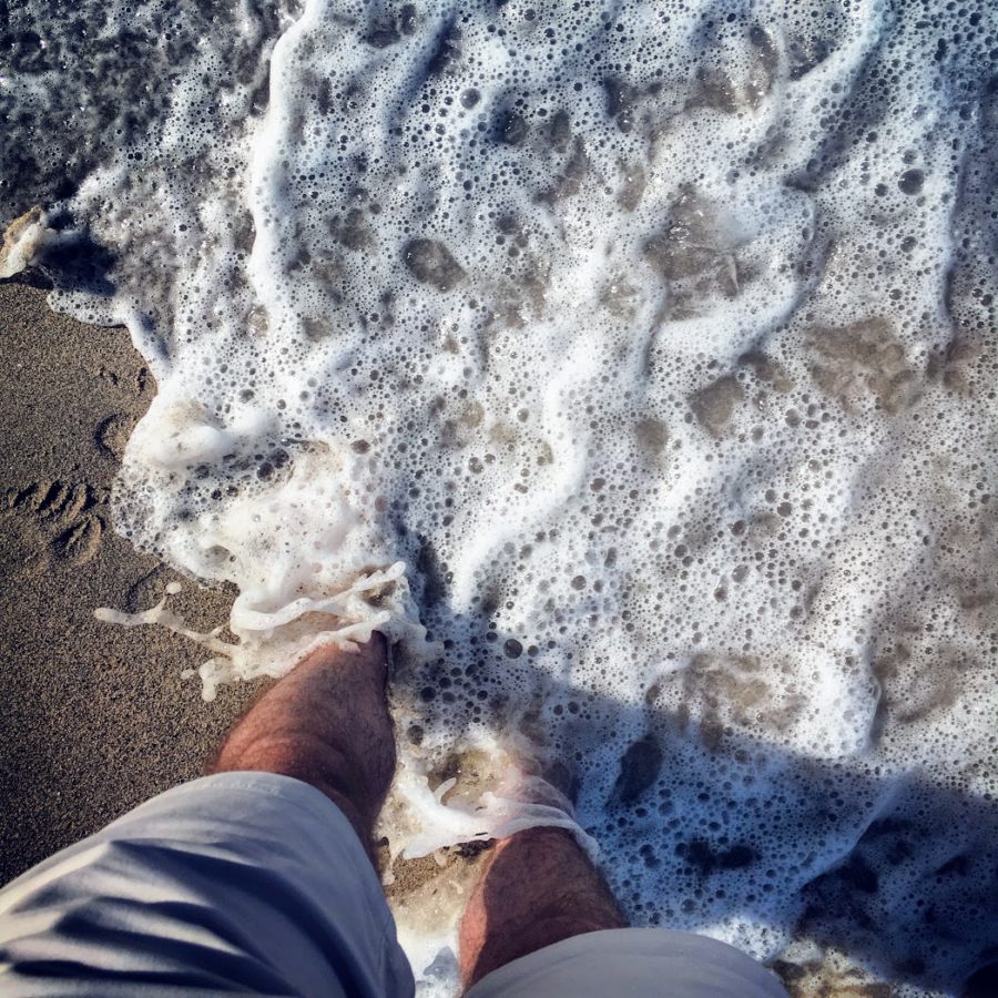 a person's legs on a beach