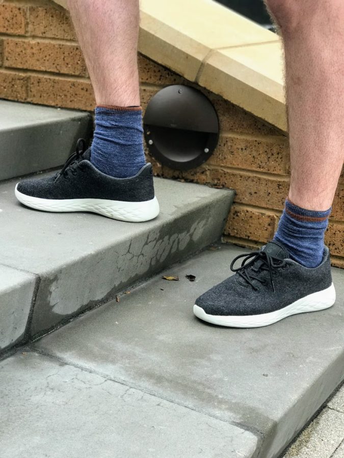 a person's legs and feet wearing socks and shoes