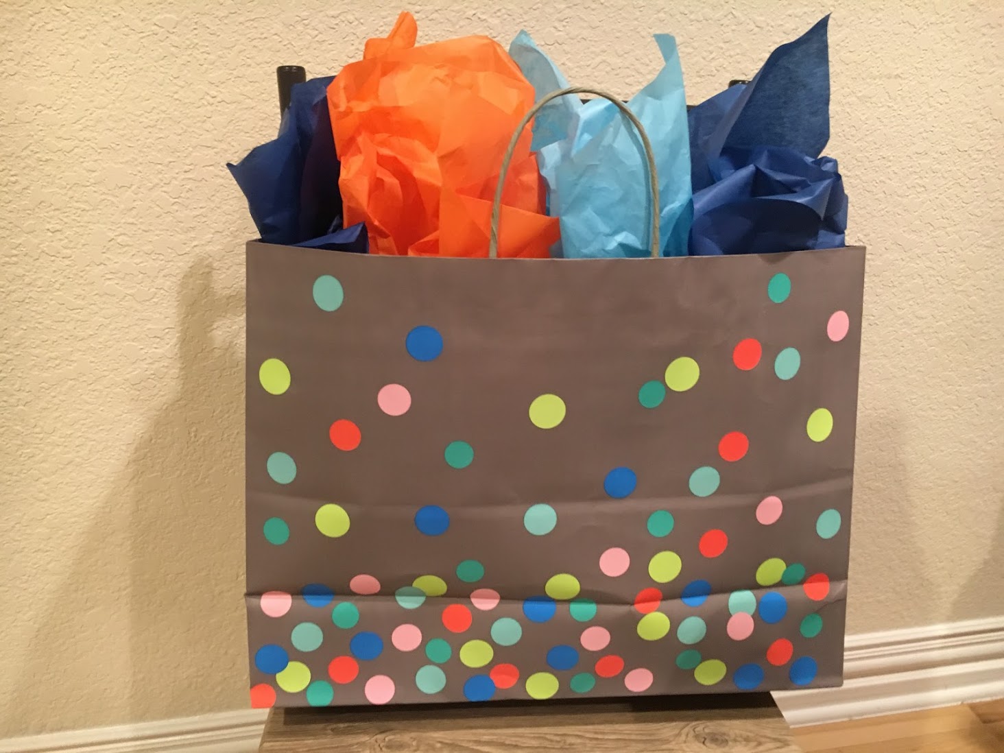 a brown bag with colorful polka dots and paper