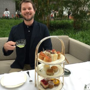 a man sitting at a table with food on it
