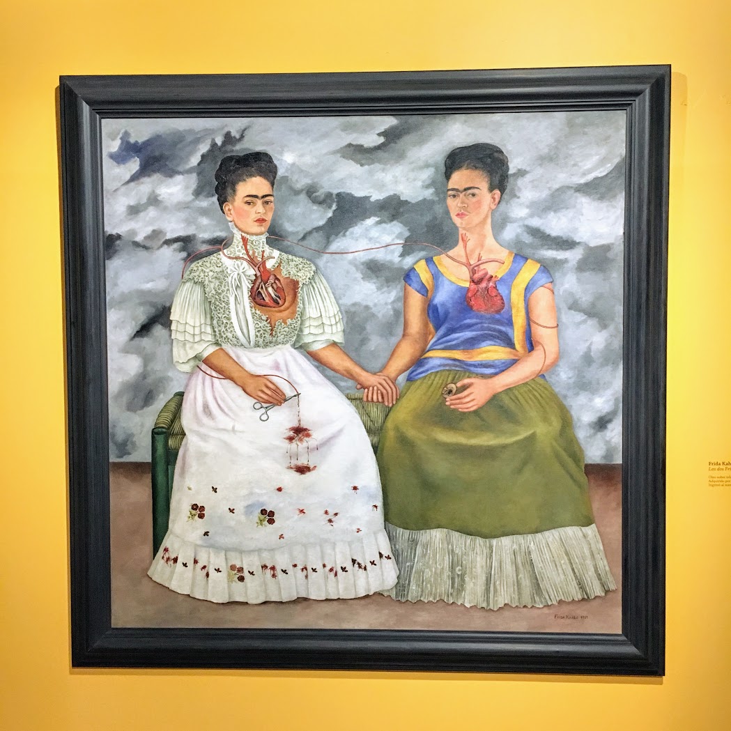 a painting of two women in dresses