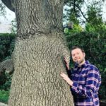 a man hugging a tree