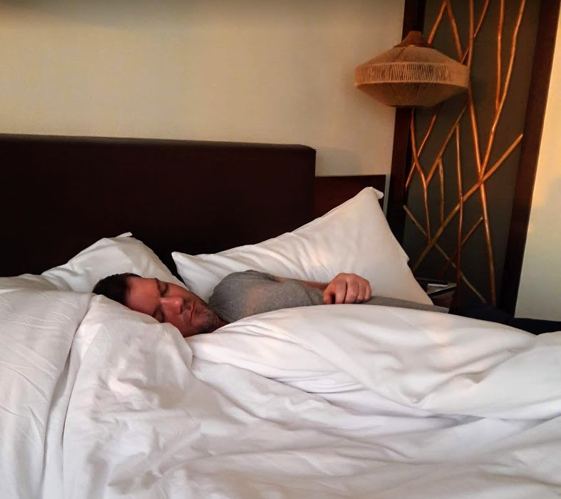 a man sleeping in a bed