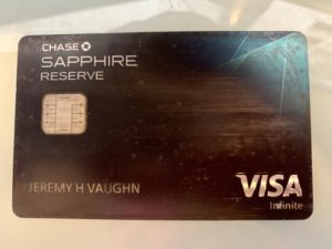 a black credit card with silver text