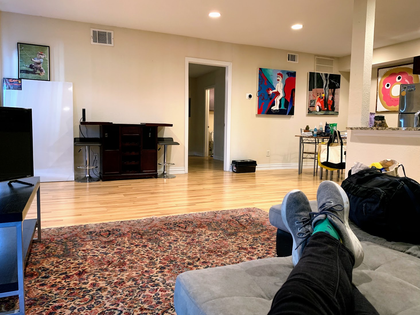 a person's legs on a couch in a living room