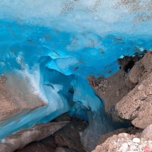 a blue ice cave with rocks