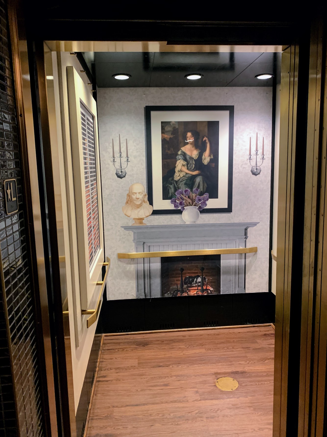 a elevator with a painting on the wall