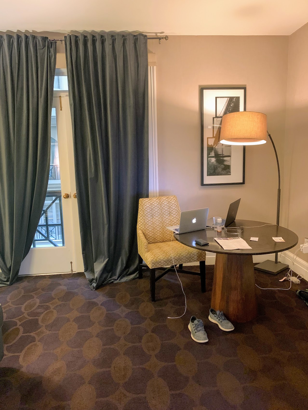 a room with a laptop and a table and chair