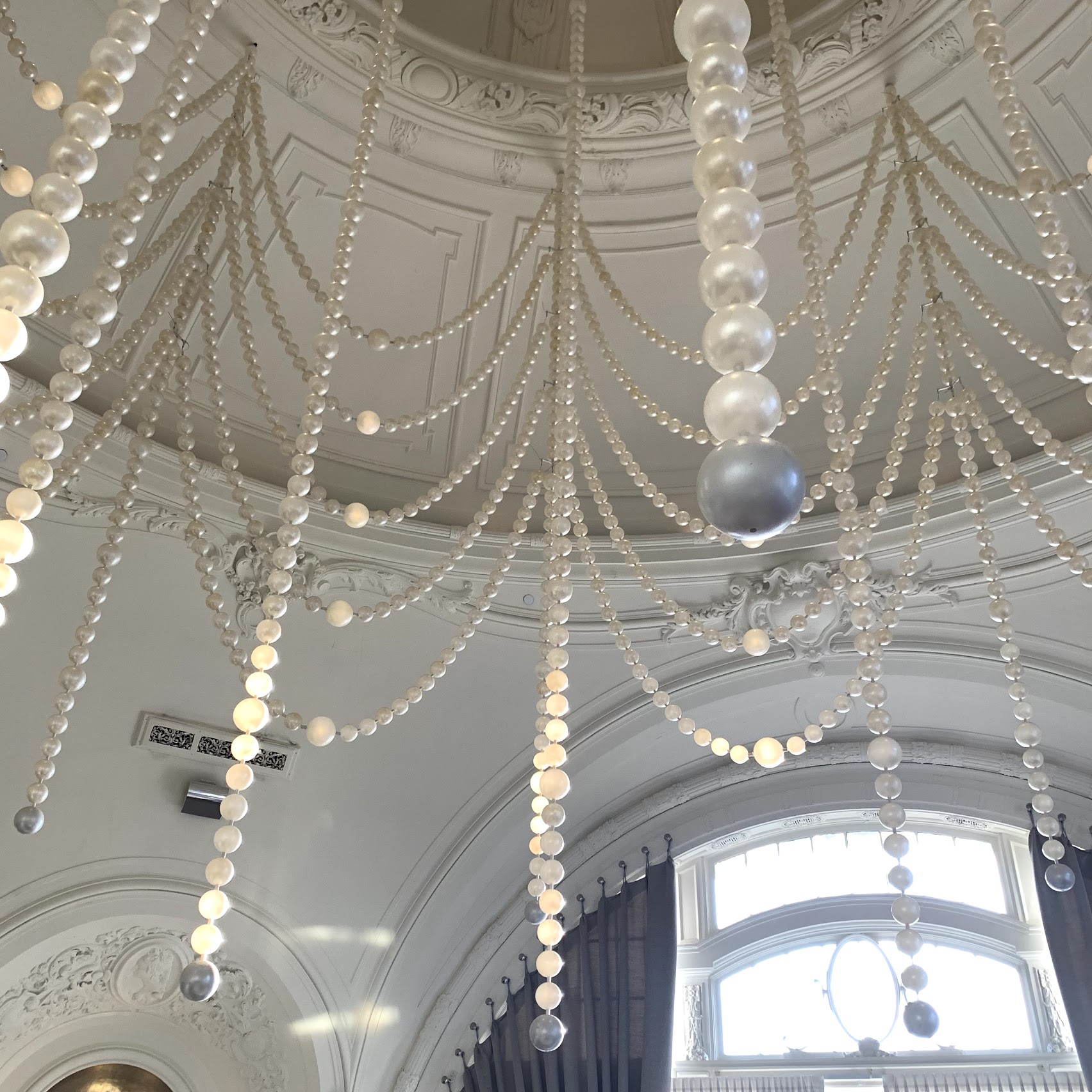 a white ceiling with pearls from the ceiling