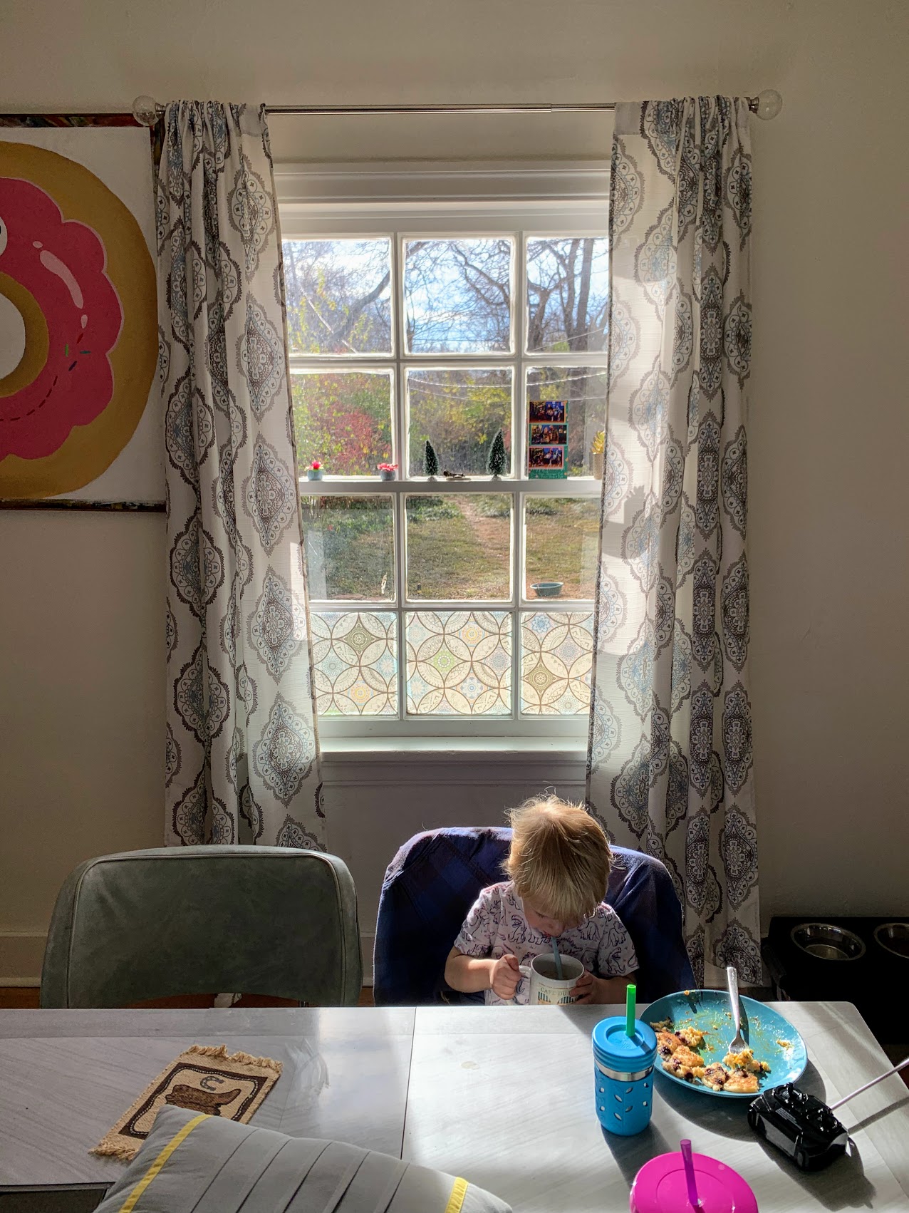 a child sitting at a table eating food