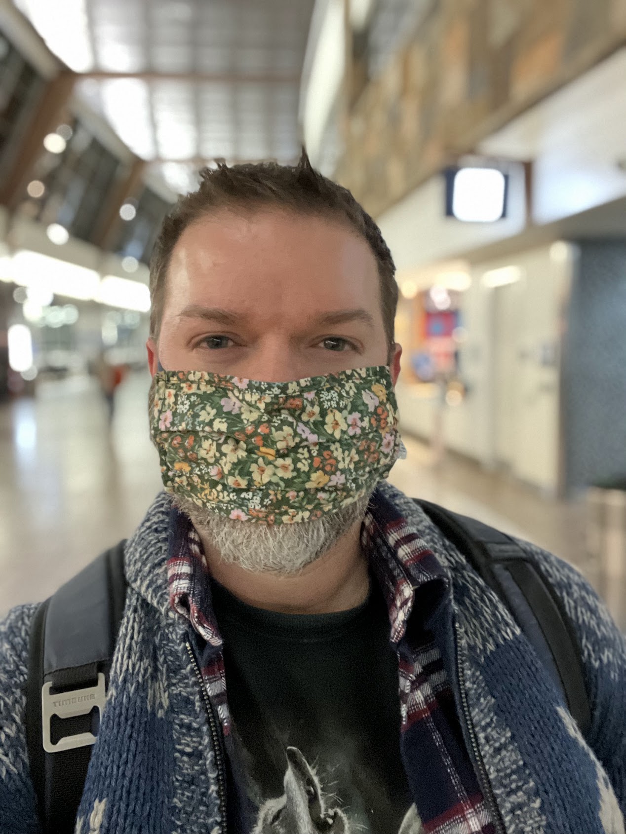 a man wearing a floral fabric mask