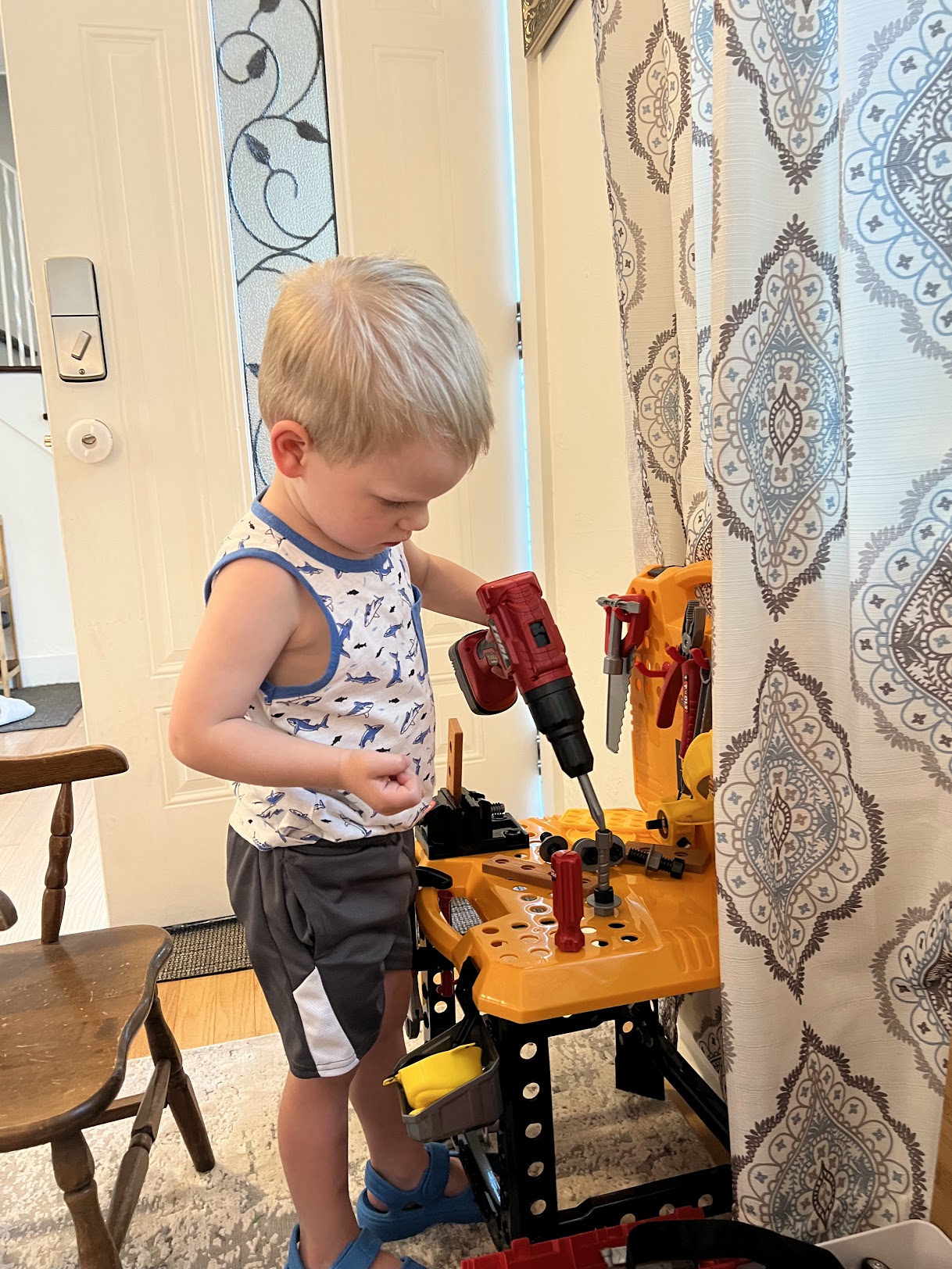 a child playing with a toy tool