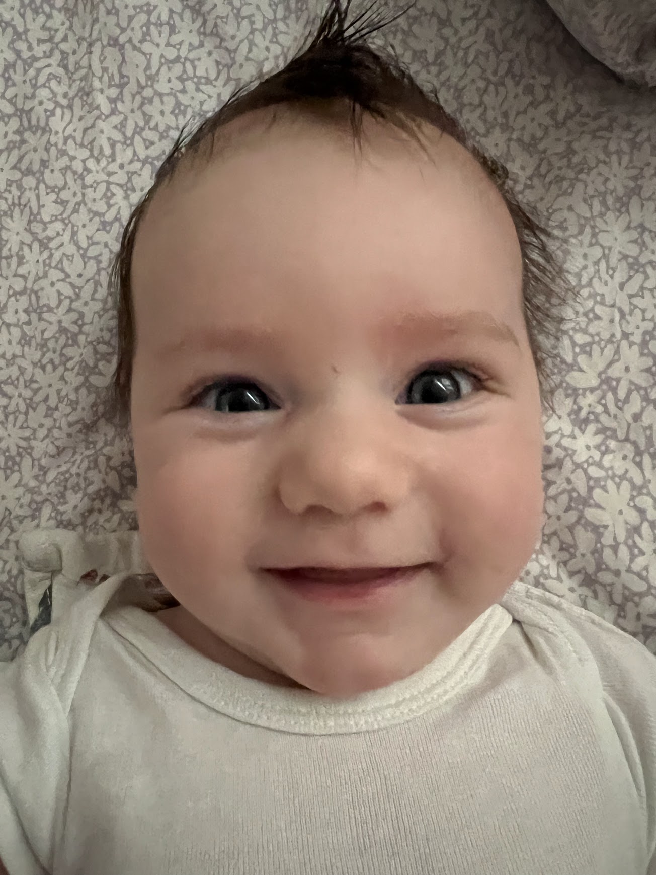 a baby smiling at the camera
