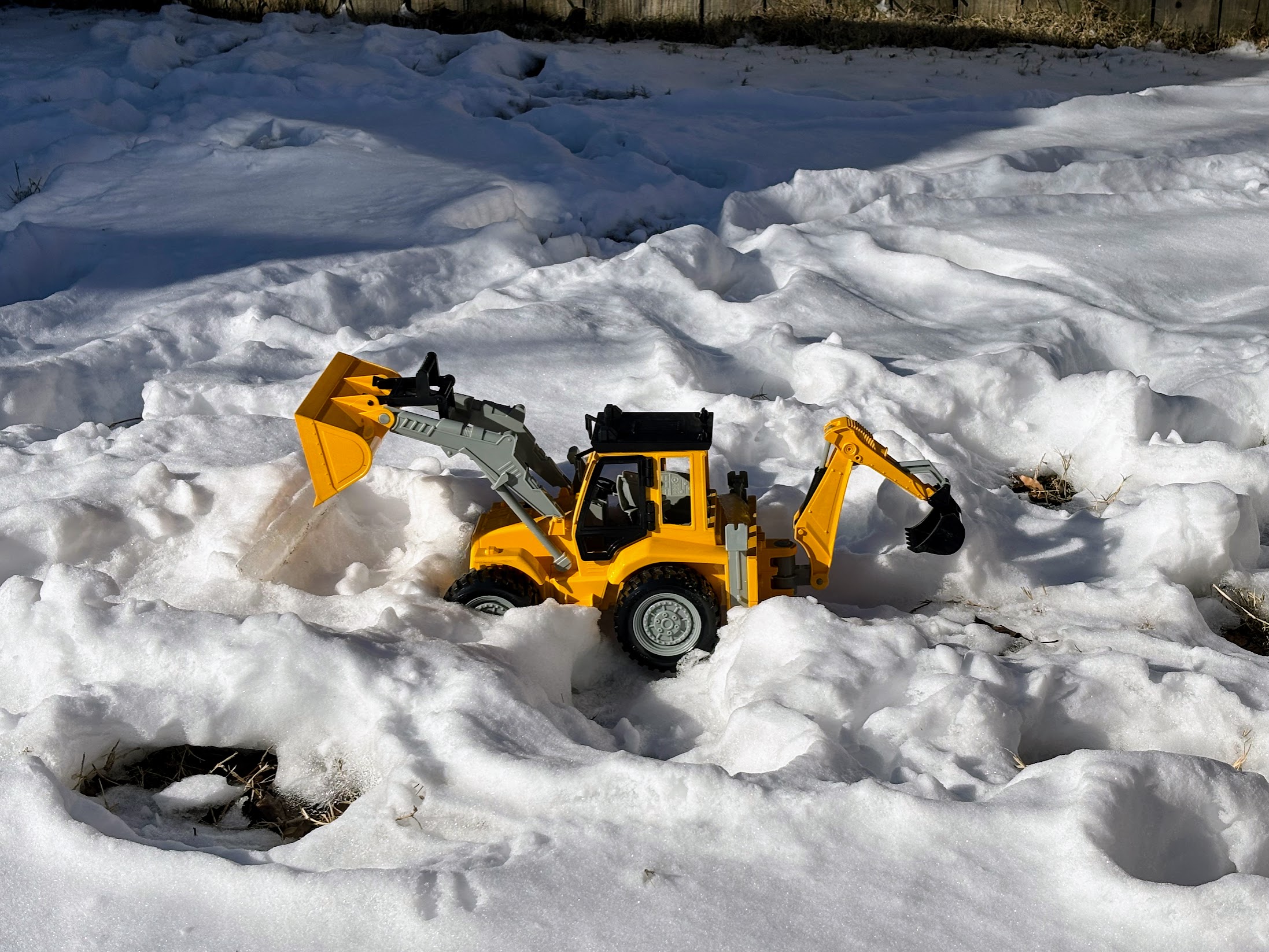 a toy tractor in the snow
