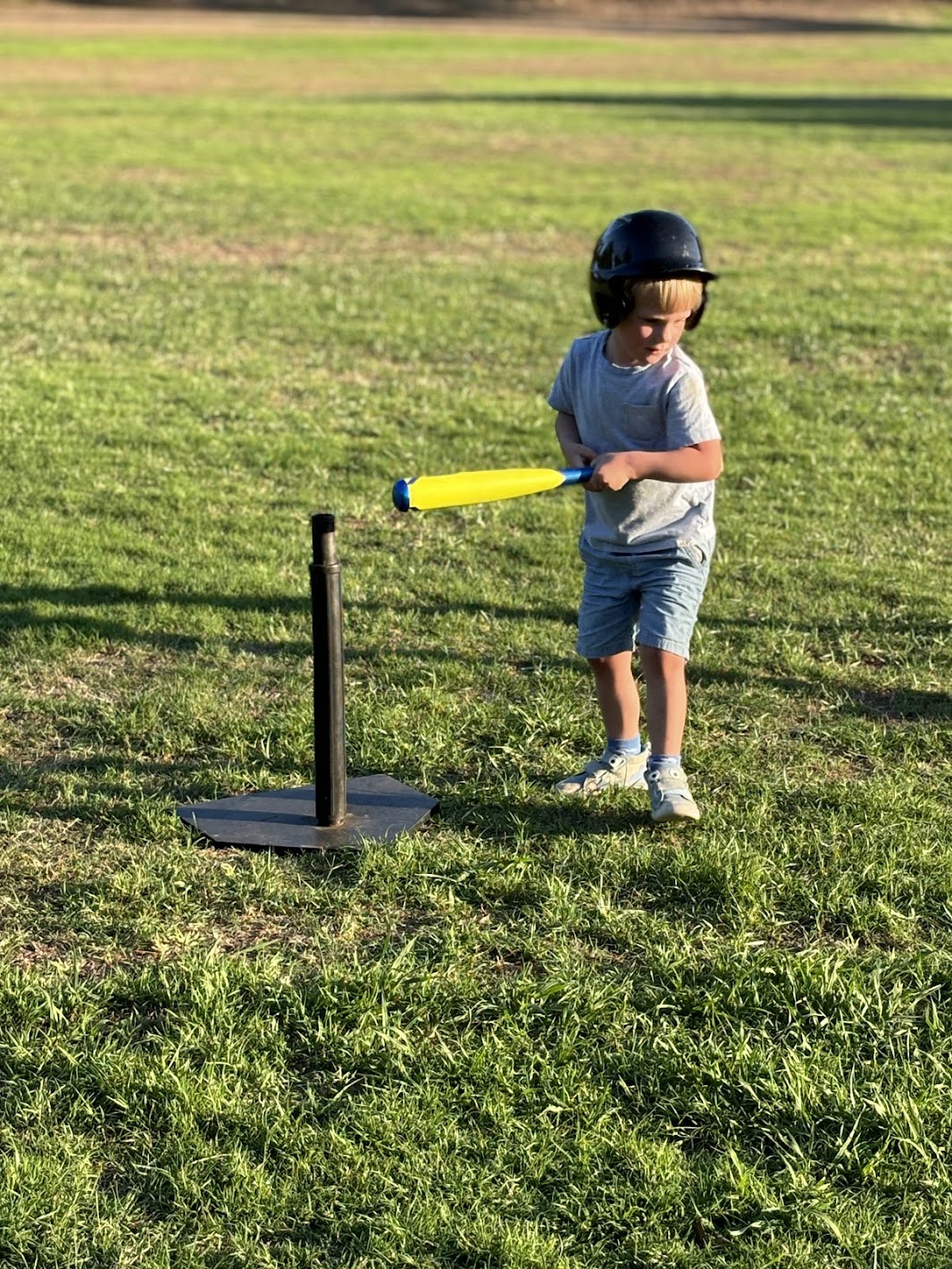 a boy playing baseball with a bat