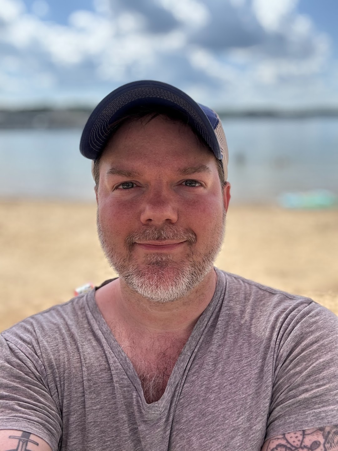 a man wearing a hat and smiling at the camera